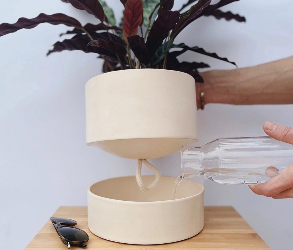 putting water in a self-watering planter